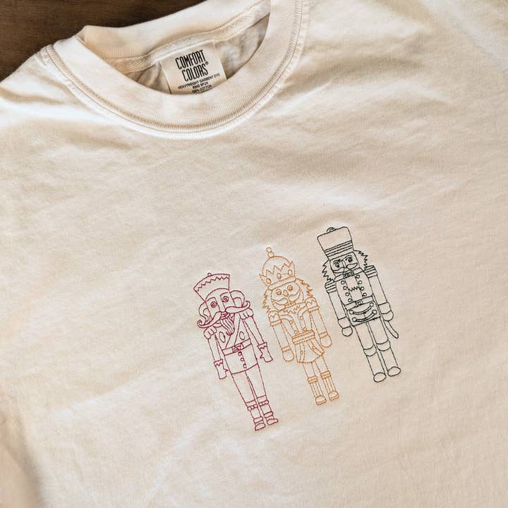 Nutcracker Trio Embroidered Christmas Tee Holiday T-Shirt for wholesale by Penelope Annen Design