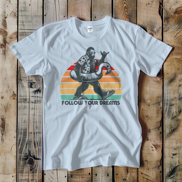 Swift Retail - Wholesale T-Shirt (Graphic) - Unisex - Follow Your Dreams Bigfoot Pool Floatie Unisex Tee
