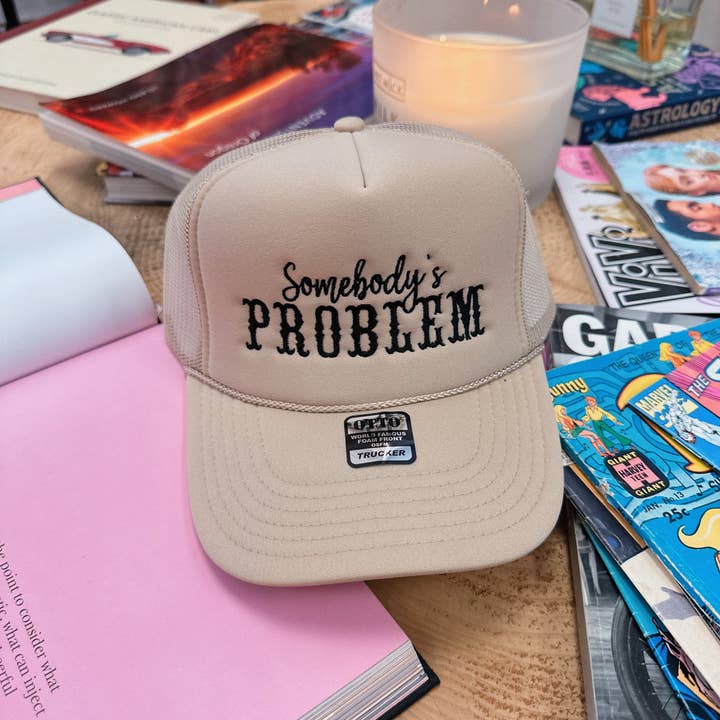 Somebody's Problem Tan Trucker Hat: embroidery and other Purchase Wholesale somebodys problem. Free Returns & Net 60 Terms on Faire trending on Faire.