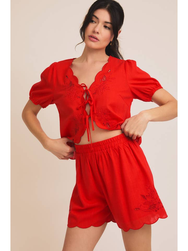 Red EYELET EMBROIDERD FRONT TIES TOP AND SCALLOP SHORTS for wholesale on Faire