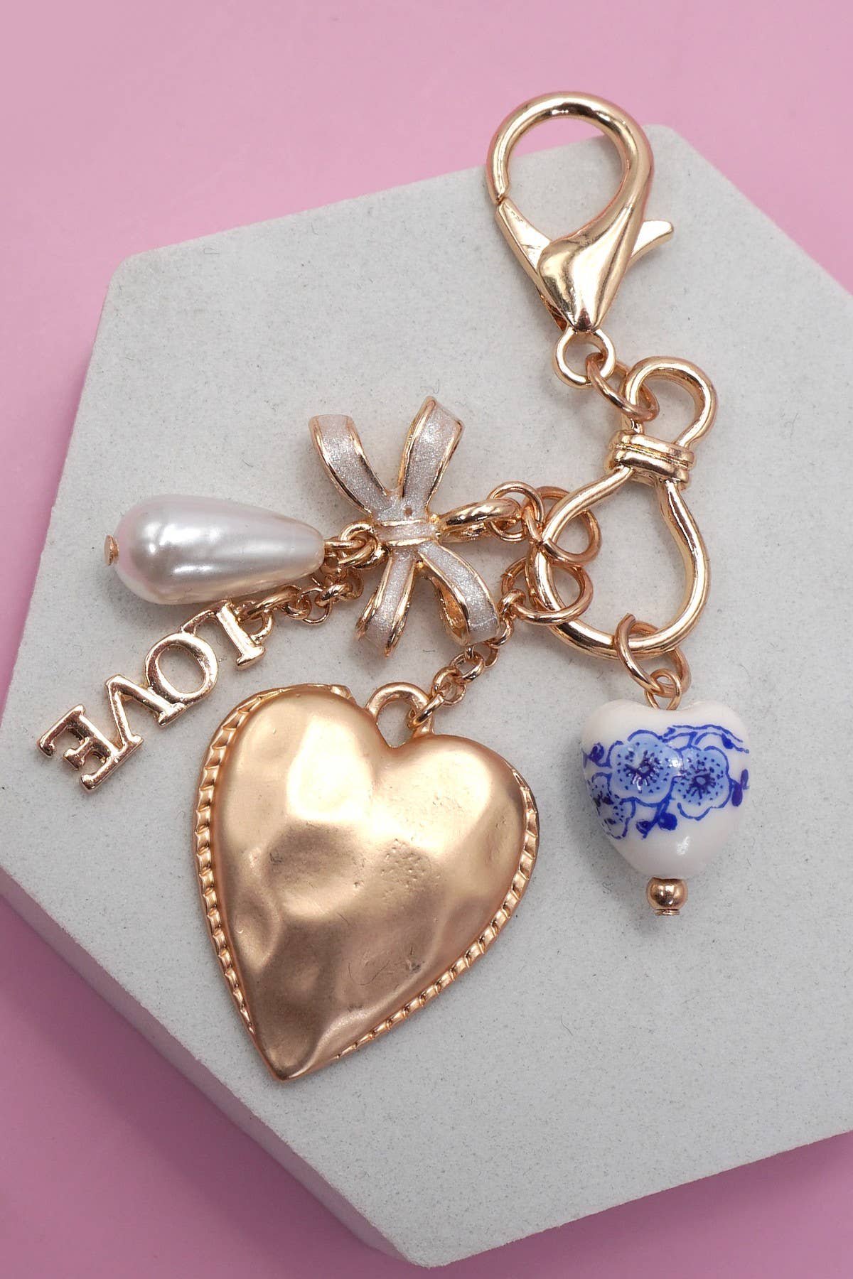 Gold PORCELAIN BOW HEART LOVE BAG CHARM | 80K011 for wholesale on Faire2