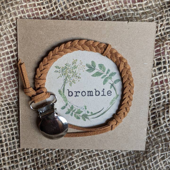 Braided faux leather pacifier clip with metal attachment for wholesale by Brombie