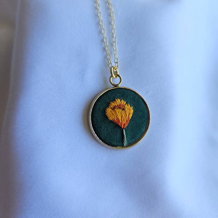 Hand-embroidered California poppy pendant for wholesale by Biobroidery