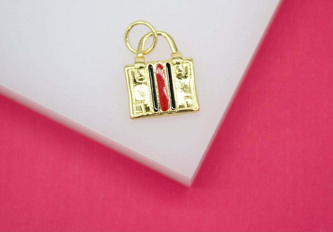 MIA Jewelry - Vente Breloques/médailles personnalisées - Breloque de sac de créateur remplie d'or 18 ct