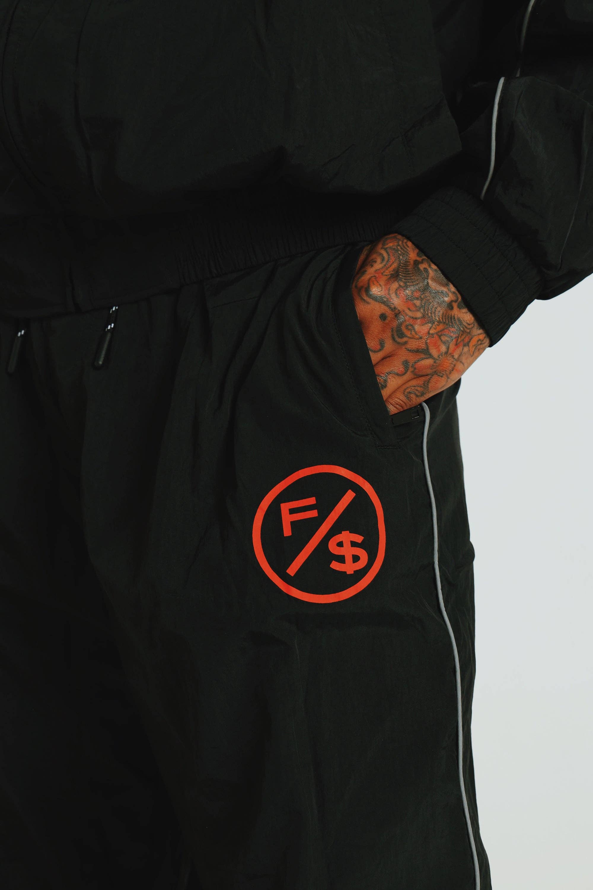 Black Red MOTION Nylon Pants (BRED) for wholesale on Faire16