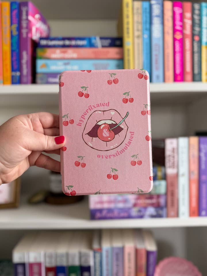 Hyperfixated and Overstimulated Cherry Clear Back Kindle Case for wholesale by The Lovebound Edit