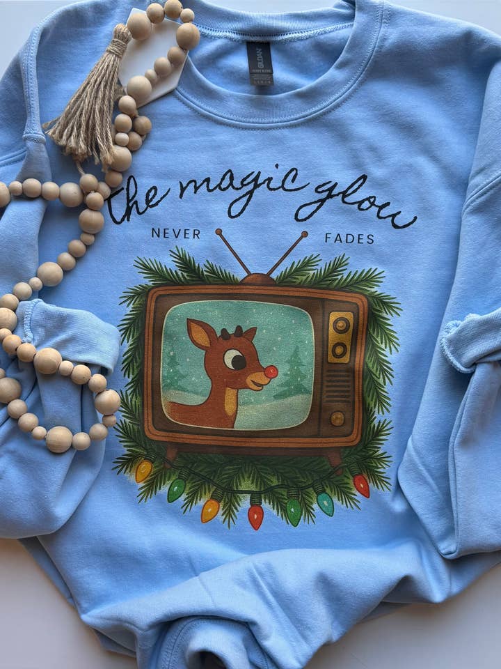 The Magic Glow Never Fades Graphic for wholesale by Sweet Rae’s Clothing Co.