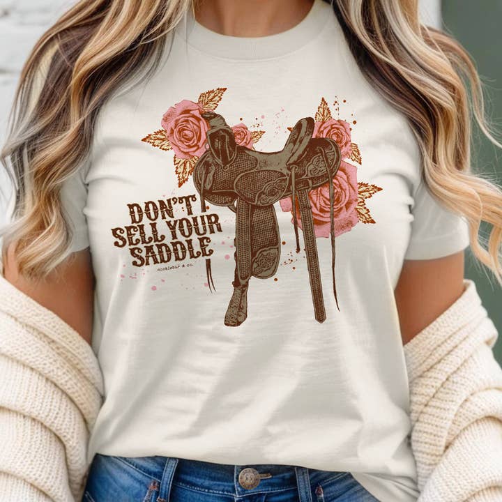 Verkauf deinen Sattel nicht – Graphic‑T‑Shirt für den Großhandel von Cocklebur & Co.