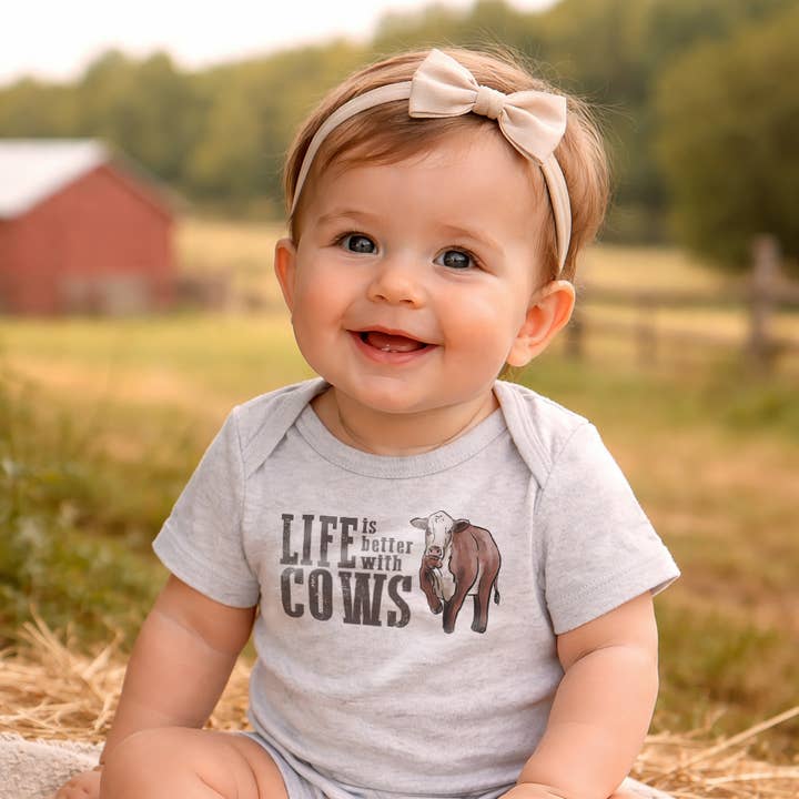 "Life is better with cows" Country Western baby bodysuit for wholesale by Barefoot Baby