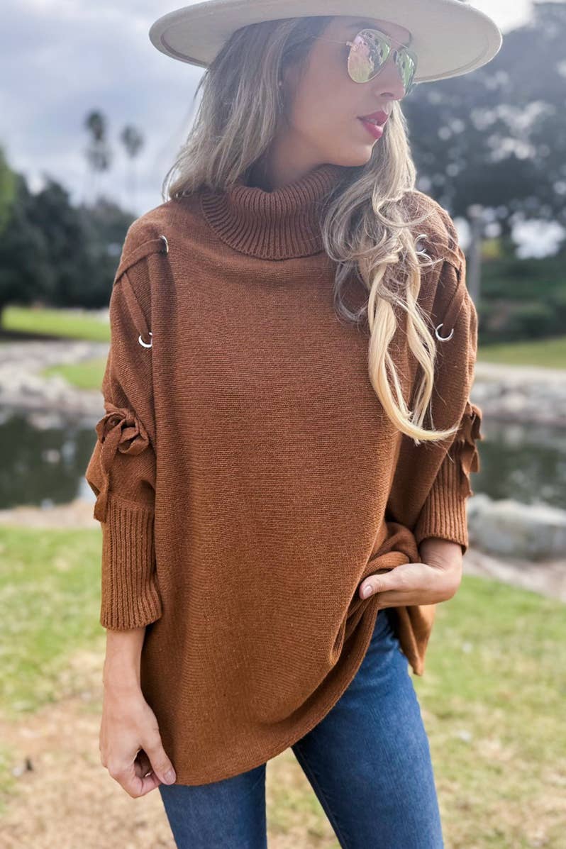Cognac Poncho in maglia a collo alto con maniche stringate color cognac in vendita all'ingrosso su Faire3