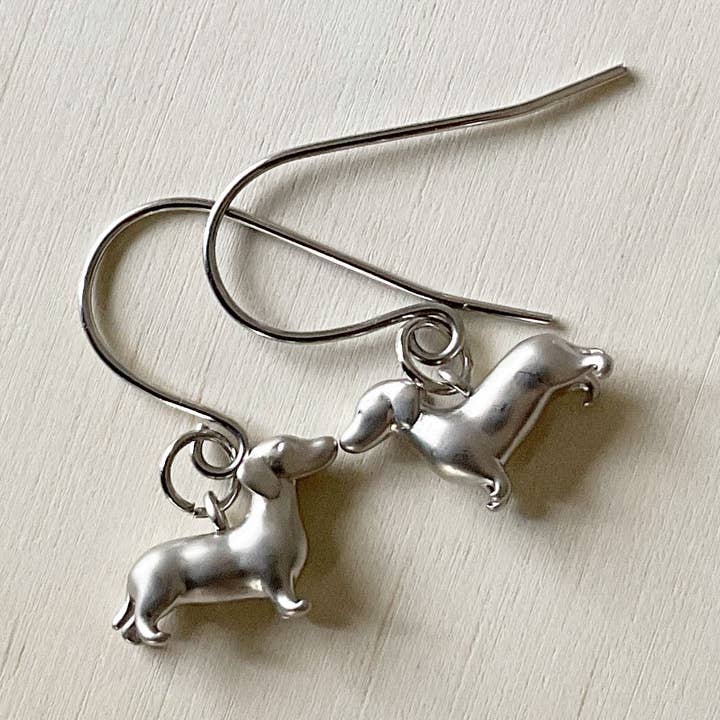 ‘Schnitzel Von Crumb’ Dachshund Earring Set - Platinum for wholesale by The Sister Label