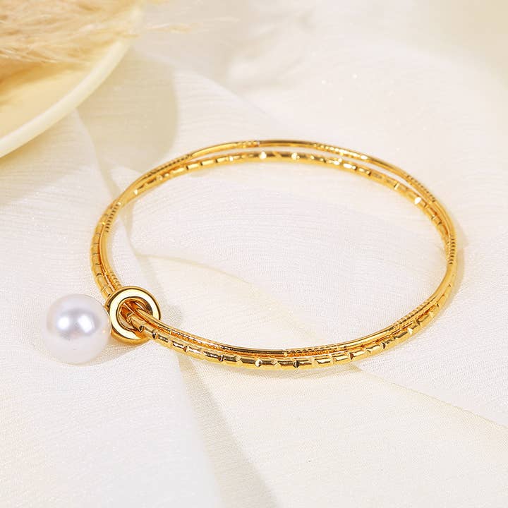 Engraved Gold Rigid Bangle Bracelet With Pearl Pendant for wholesale by JOYA
