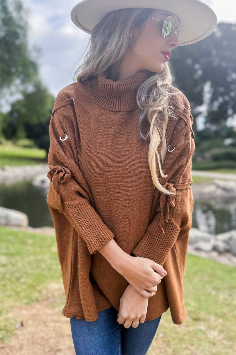 Cognac Poncho in maglia a collo alto con maniche stringate color cognac in vendita all'ingrosso su Faire7
