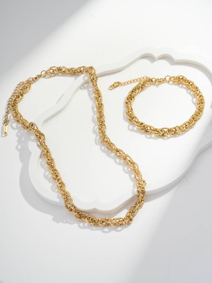 Twisted gold-plated necklace and bracelet set in stainless steel for wholesale by COSMOS
