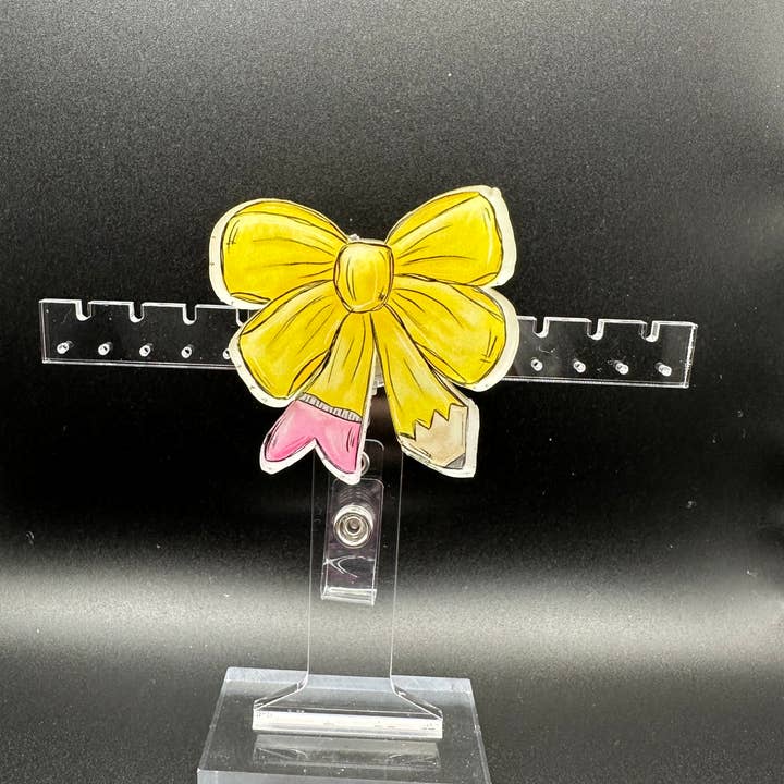Teacher’s Pencil Bow Badge Reel – Perfect for Educators for wholesale by Hello Darling Designs
