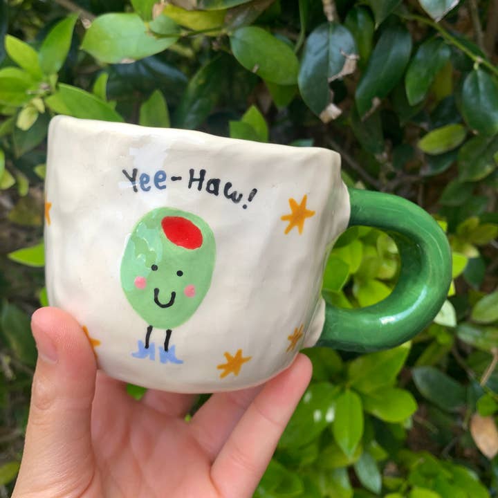 'Fruits in Boots' Ceramic Coffee Mug - Olive for wholesale by Howdy Ceramics