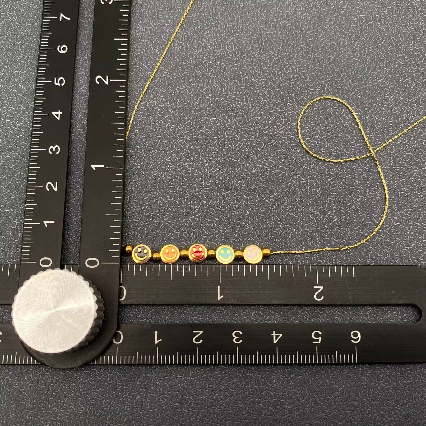 Mio Queena - Vente Colliers à pendentif - Collier en acier inoxydable plaqué or 18K avec 5 visages souriants en émail - FGS2