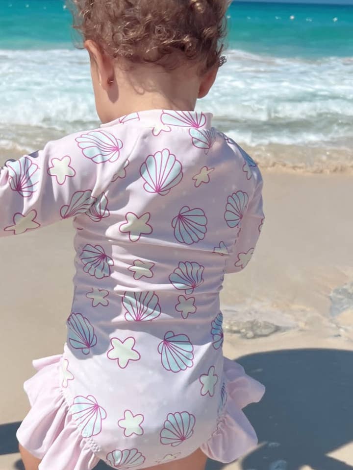 Mermaid Drift – Lavender Seashell Rashguard With Ruffles for wholesale by Uncommon Lane