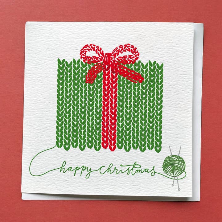 Knitter’s Christmas Card: Green & Red Wrapped Present for wholesale by And Hope Designs - Cards, Stickers & Stationery