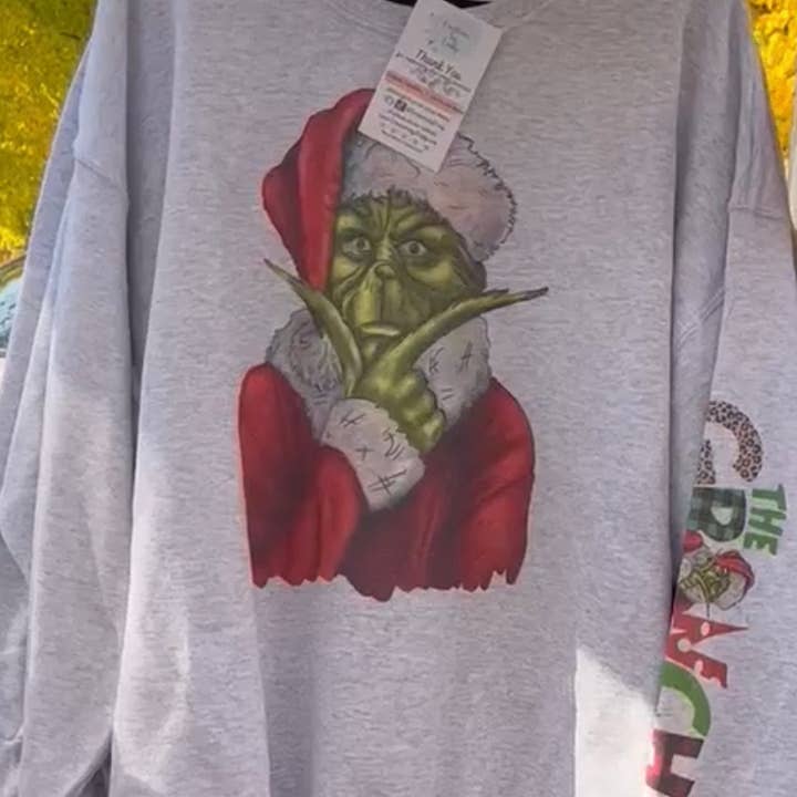 Grinch Face With “The Grinch” on Sleeve- Crewneck Sweatshirt for wholesale by Creations by Trudy