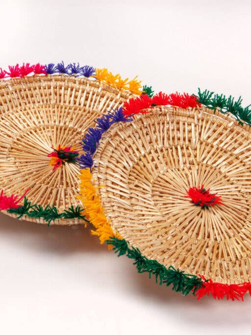 Multicolor fringe basket made of handwoven palm leaf for wholesale by Intertrade s.a