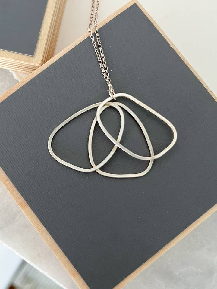 Sterling silver poppy necklace, wire charm, abstract flower for wholesale by Tina Welsch Jewelry