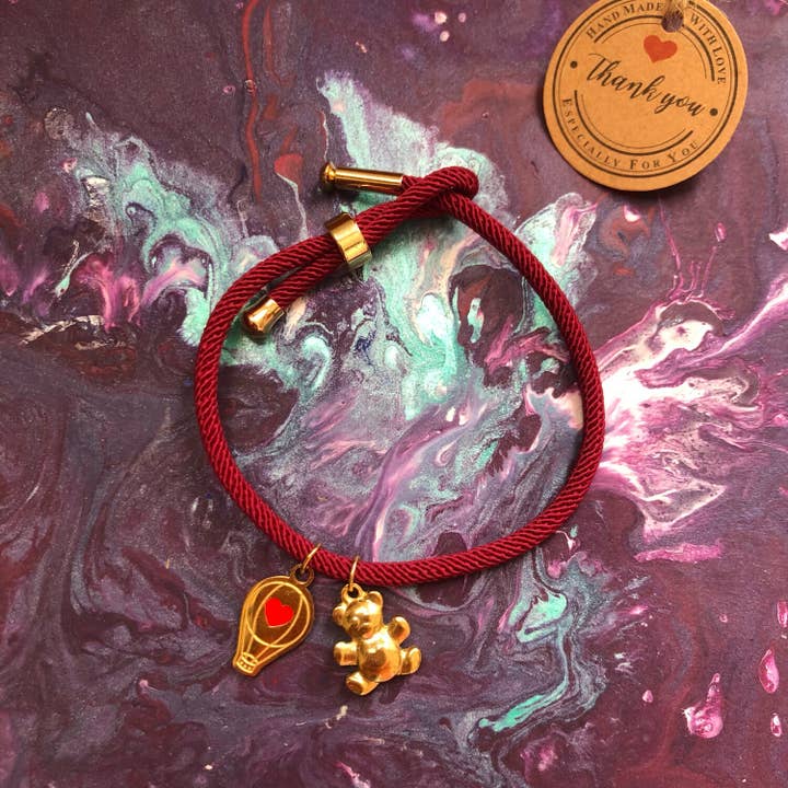 bracciale bordeaux con orsetto e mongolfiera per la vendita all'ingrosso da parte di le antiche erbe
