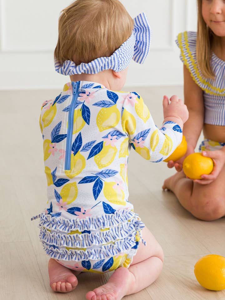 Baby Girls Lemon Capri Long Sleeve One Piece Rash Guard Swimsuit with Signature Rear Ruffles
 for wholesale by RuffleButts + RuggedButts