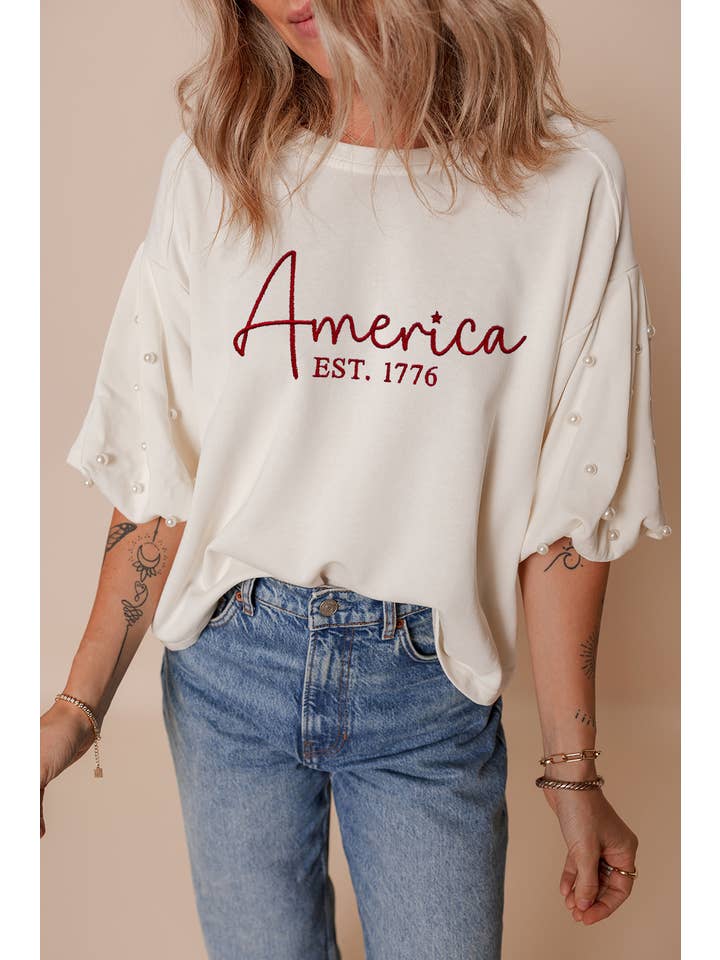White LDC America EST 1776 Embroidered Pearl Beaded T Shirt for wholesale on Faire