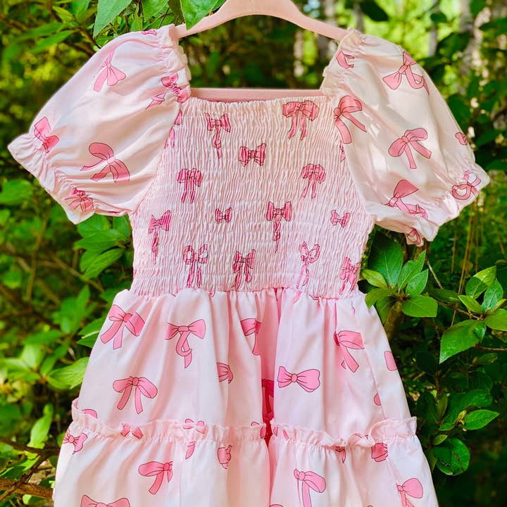 Pink Bows Smocked Onesie for wholesale by Luminous Sky Bowtique