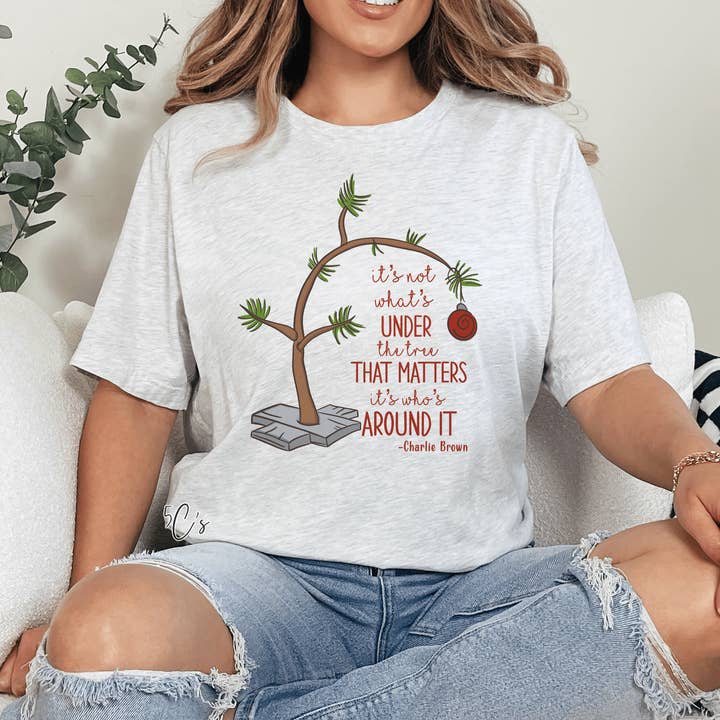 It's Not What's Under The Tree Graphic Tee and other Purchase Wholesale under 5. Free Returns & Net 60 Terms on Faire trending on Faire.