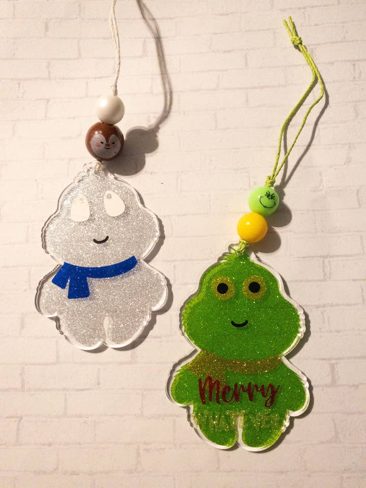 Funny Green Monster Ornament, Cute White Monster Ornament, Grumpy Green Guy Ornament, Merry Whatever Ornament for wholesale by Chasin’ Self Care