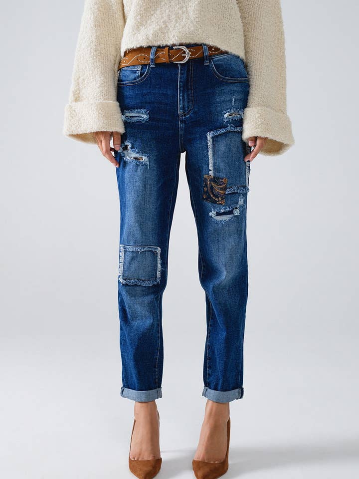 Loose blue jeans with subtle ripped design and patches for wholesale by Q2—All Orders:Free Duties for the US,UK,and Canada