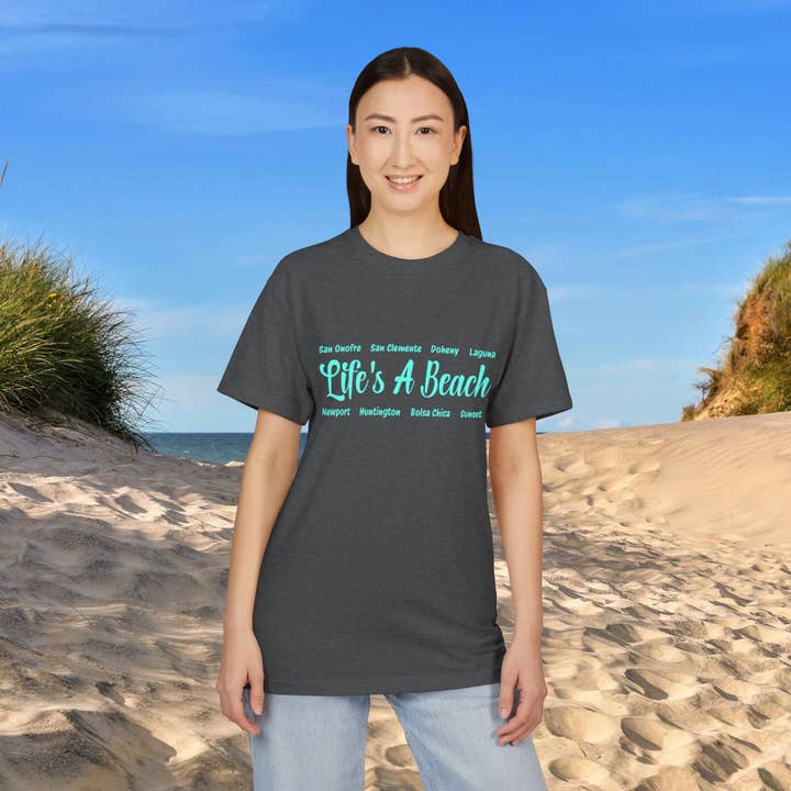 Maglietta Grafica Unisex in Cotone Scamosciato – Life’s A Beach – Design Costiero per la vendita all'ingrosso da parte di Restored By Nature Company