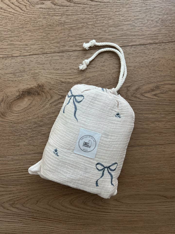 Blue Bows Cotton Gauze Crib Sheet for wholesale by Dreamy Skies Baby