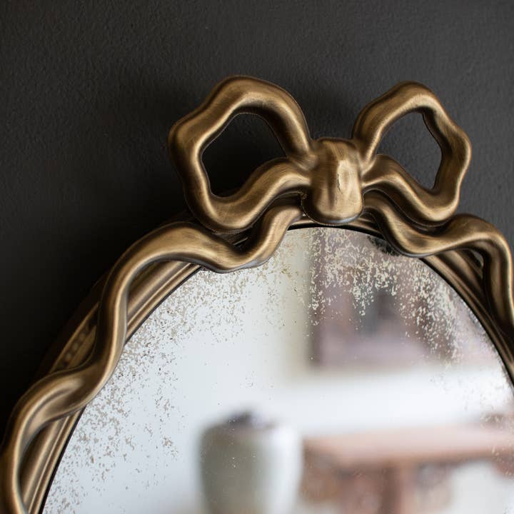 Gold FRAMED ANTIQUE GLASS MIRROR WITH BOW  for wholesale on Faire2