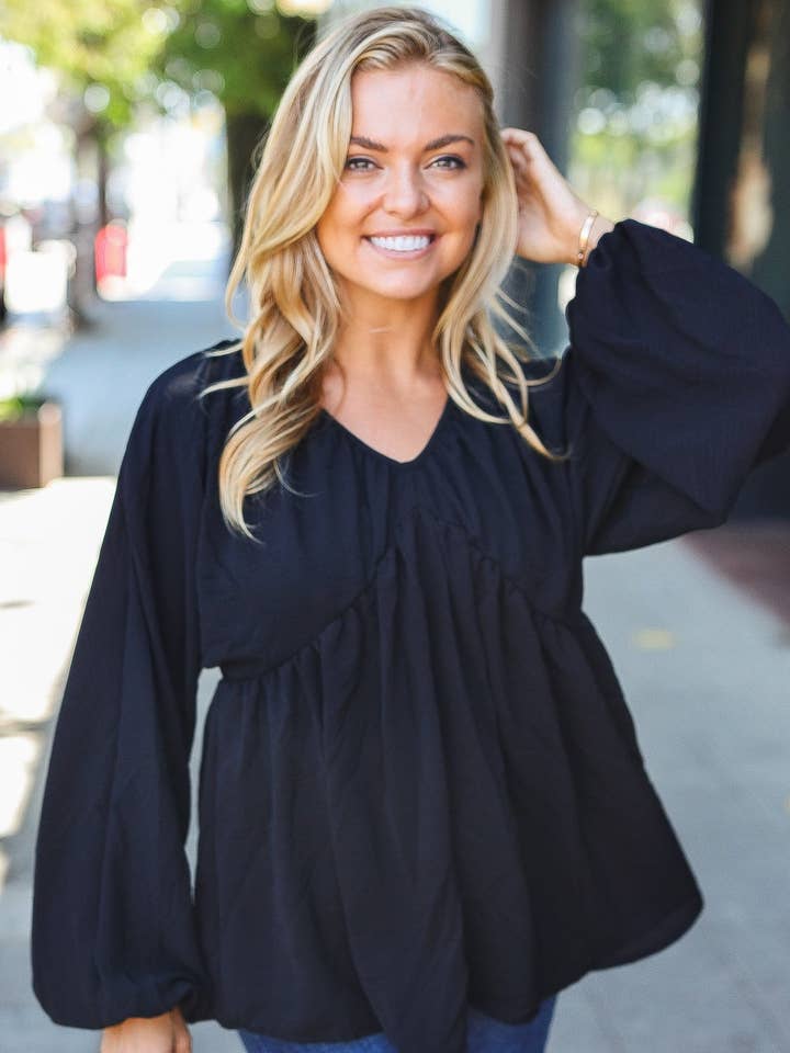 Top nero con design babydoll in tessuto spesso per la vendita all'ingrosso da parte di Promenade