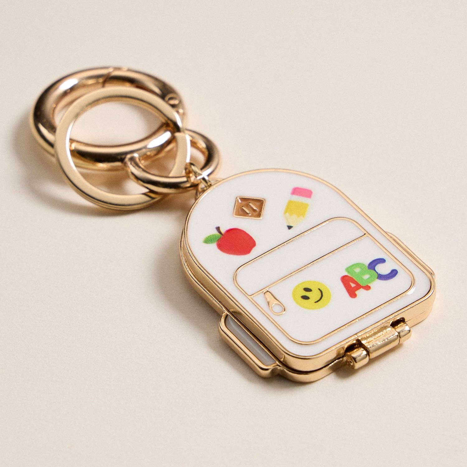IV Gold Backpack Locket Keychain with School Supply Icons for wholesale on Faire4