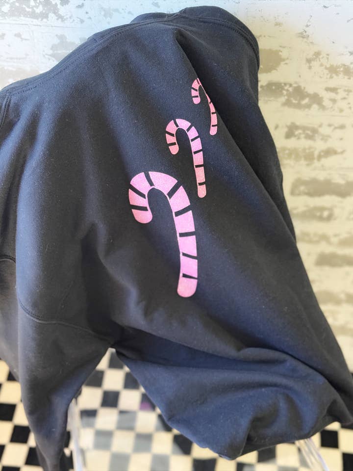 Candy Cane Lane Monogrammed Hoodie – White or Black Pullover with Glitter Monogram & Candy Cane Graphic for wholesale by The Maximalist Boutique