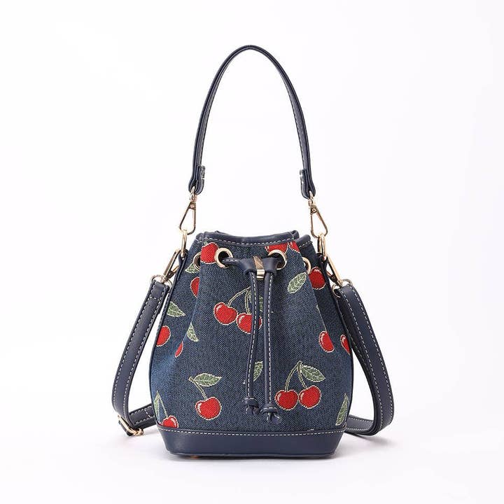 Cherry Bucket Handbag on Blue Backdrop for wholesale by Signare London