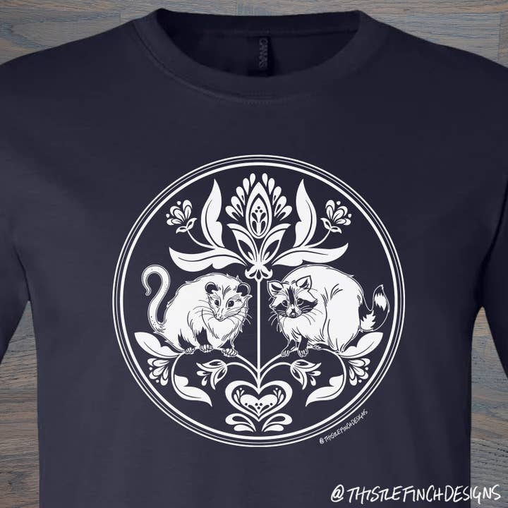 Raccoon & Opossum Hex Sign Unisex T-Shirt for wholesale by Thistle Finch Designs