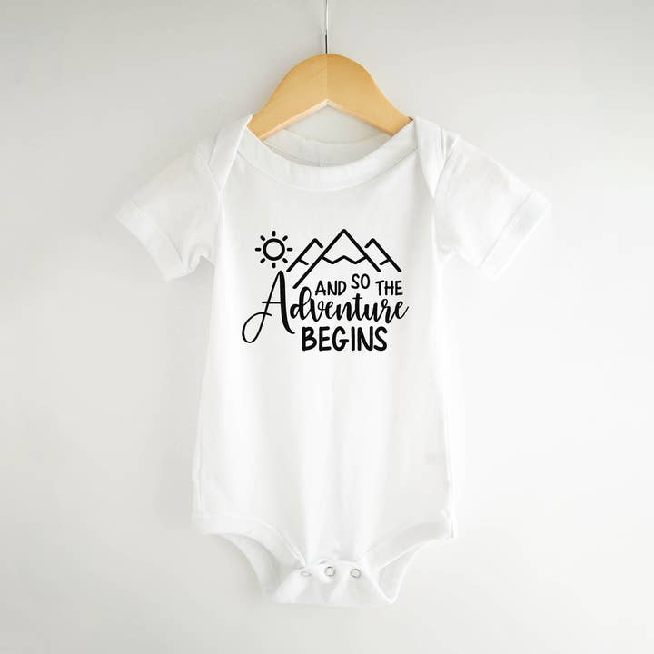 And so the Adventure Begins Pregnancy Announcement Onesie for wholesale by Bump & Beyond Designs