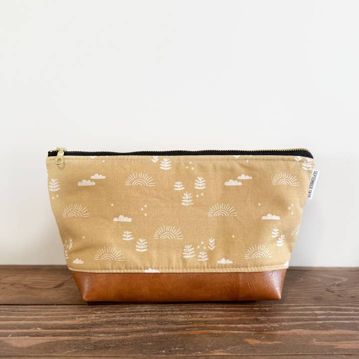 Makeup bag in mustard clouds and trees for wholesale by September Skye Bags & Accessories