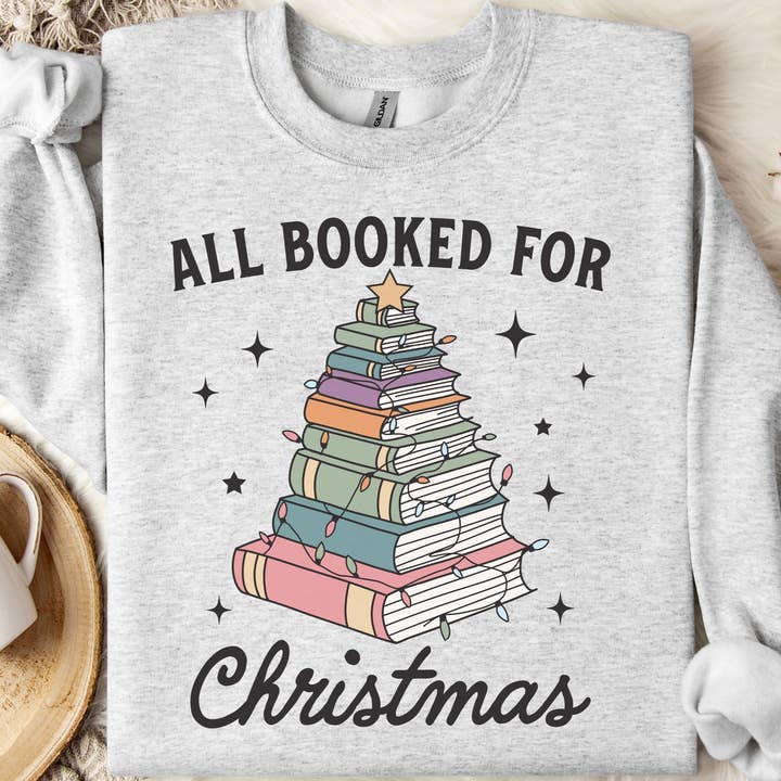 All Booked for Christmas Bookish Sweatshirt for wholesale by Nearly June Design Co