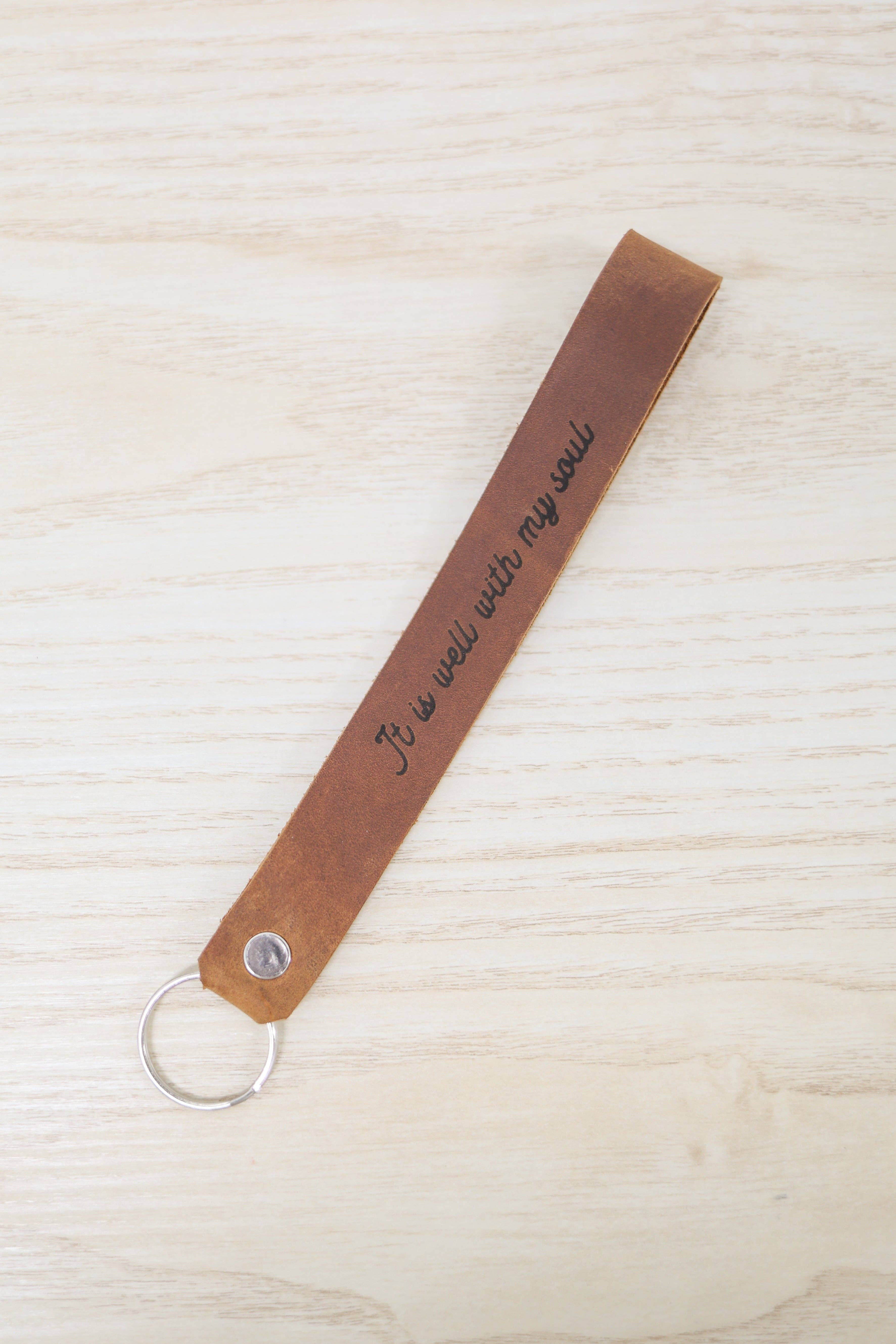 Jubilee Trading Co.  |  Ethical Trade Decor + Accessories - Wholesale Keychain - Unisex - It Is Well With My Soul Wristlet Engraved Leather2