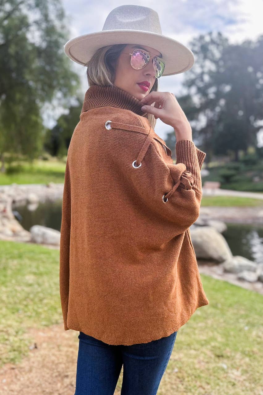 Cognac Poncho in maglia a collo alto con maniche stringate color cognac in vendita all'ingrosso su Faire8