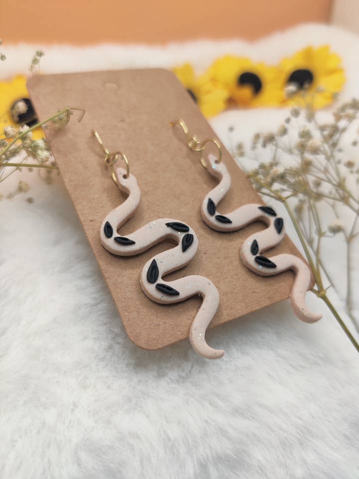Sparkly Beige Snake Polymer Clay Earrings with Black Leaves for wholesale by Sunflowercrafty