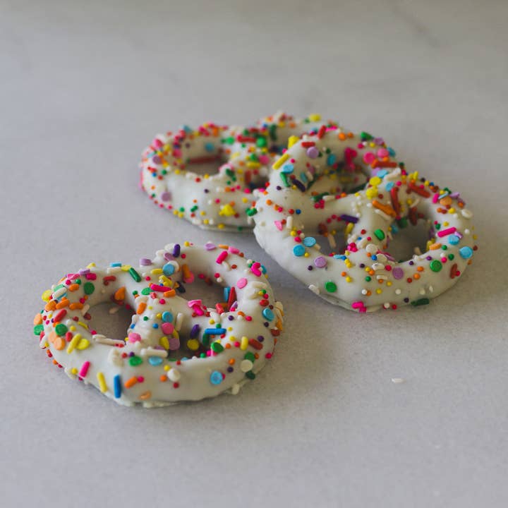 White Chocolate 3-Ring Pretzels with Sprinkles / 3lb. Case for wholesale by Maggie Lyon Chocolatiers