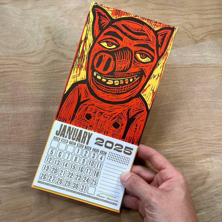 Pioneer House (formerly Yee-Haw) - Wholesale Calendar - 2025 Smiling Pig Woodcut Mini Calendar