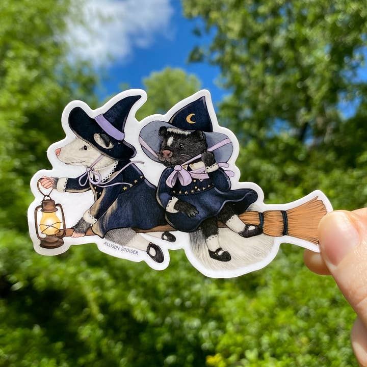 Flying Witch Opossum and Skunk Weatherproof Vinyl Sticker for wholesale by Allison Stoiser Art
